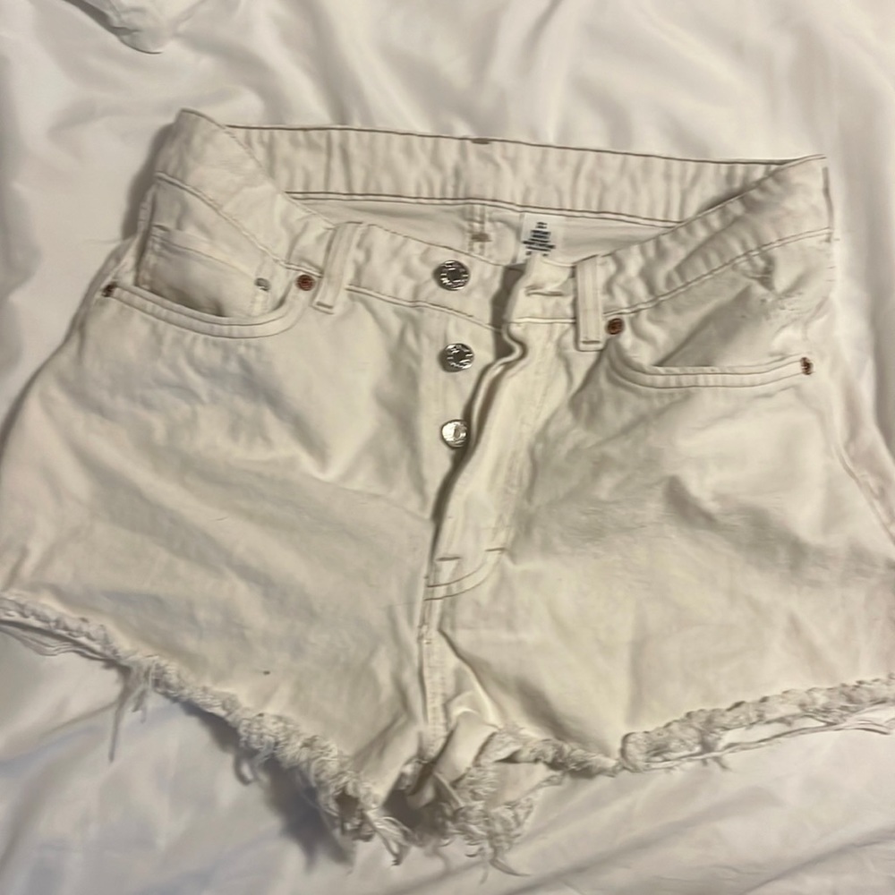 White distressed jean shorts.